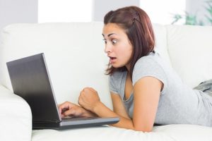 surprised girl looking at laptop computer