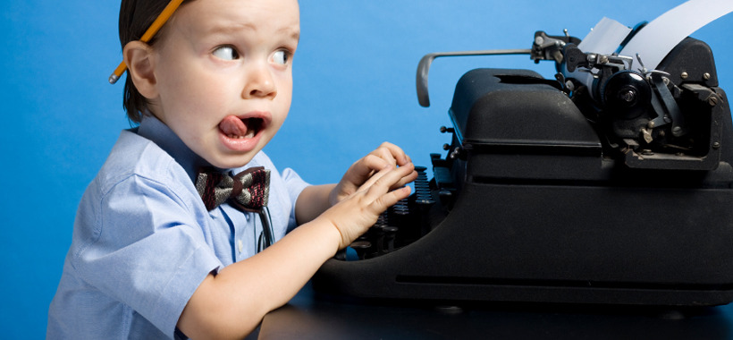 Upset child sitting at typewriter