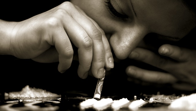 Man snorting a line of cocaine