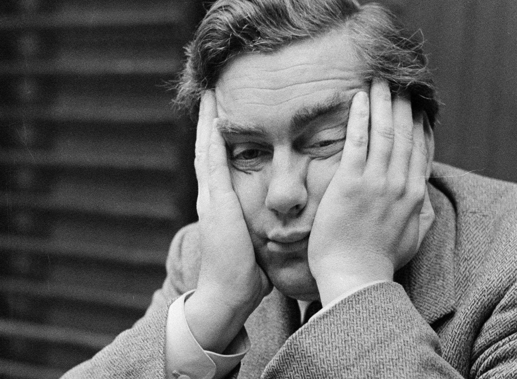 Bored man sitting with hands on his face