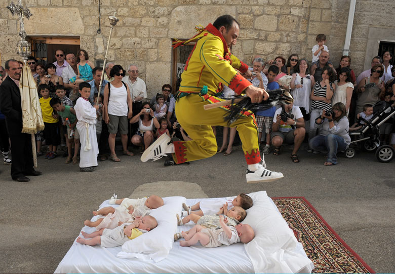 Man jumping over a line of screaming babies