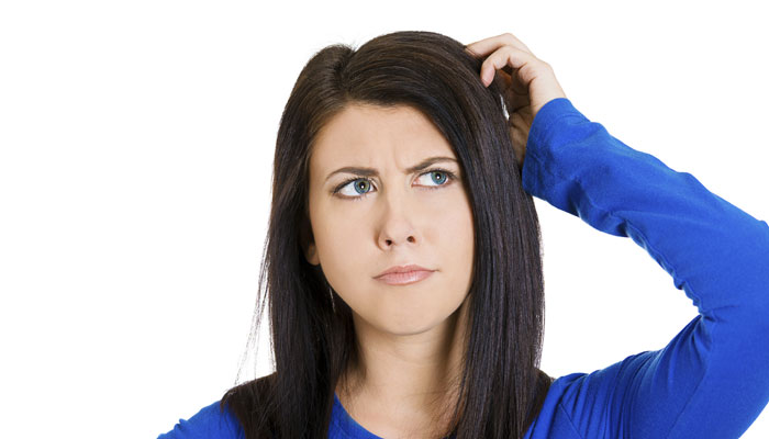 Woman scratching her head, trying to remember something
